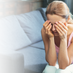 Woman sitting with her head in her hands.